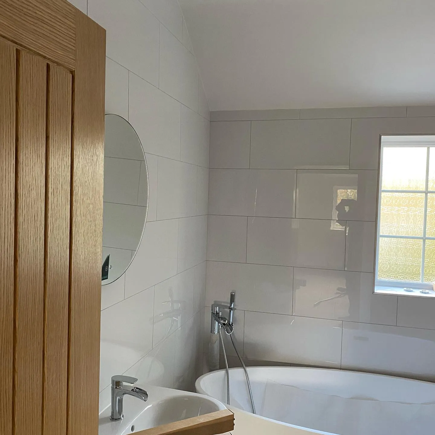 white bathroom with wooden door