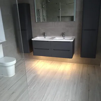 a bathroom with two sinks and a toilet