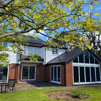 a large white house with a large tree in front of it