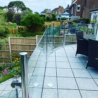 a patio with a table and chairs and a fence